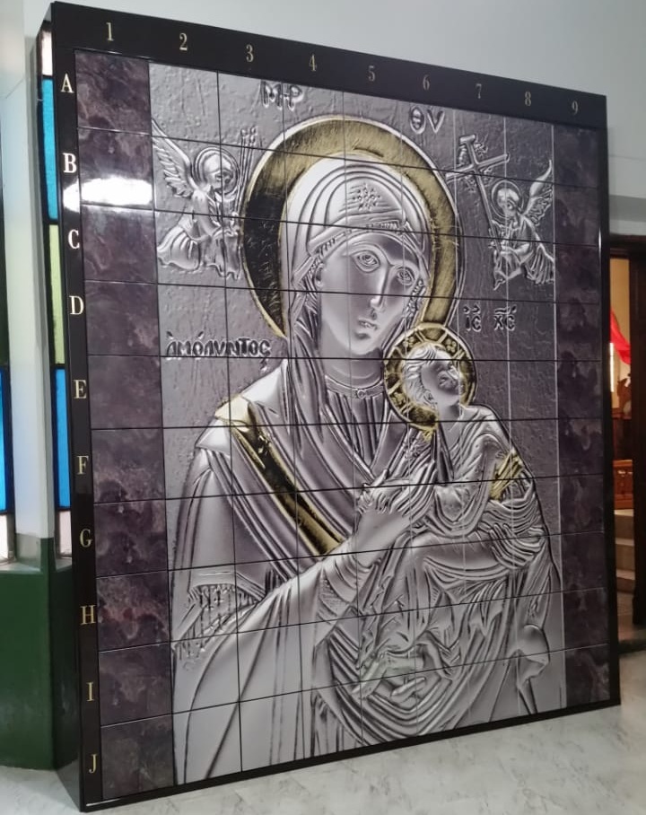 Criptas Mural en mosaico de estilo iconográfico que representa a la Virgen con el Niño Jesús, con detalles en dorado y numeración en los bordes